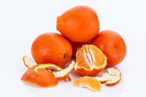 oranges, three whole and one peeled